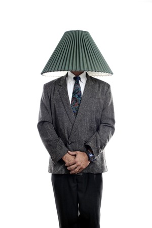 Businessman with a lamp shade covering his headの写真素材