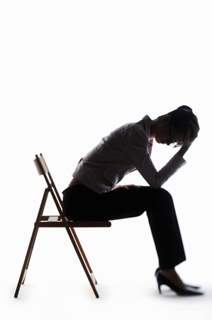 Silhouette of a depressed businesswomanの写真素材