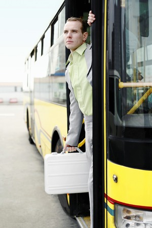 Businessman getting down from a bus