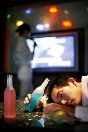 Drunk man sleeping in the karaoke lounge