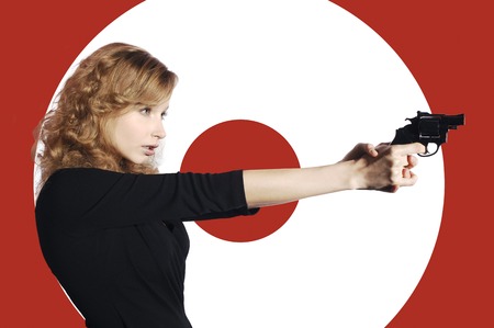 Businesswoman aiming a pistol