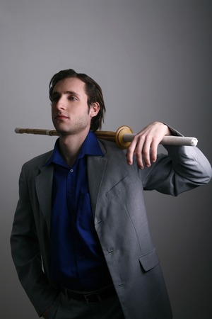 Businessman posing with a sword