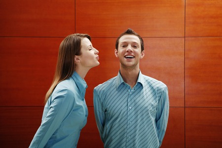 Woman about to give man a kiss 