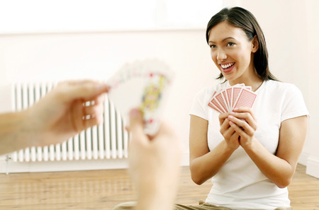 Woman playing cards with her boyfriend