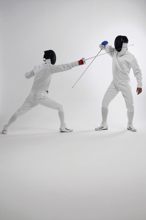 Two men in fencing suits dueling