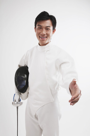 Man in fencing suit extending hand for a handshake