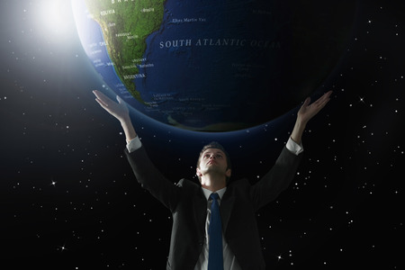 Businessman lifting up a globe