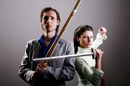 Businessman and businesswoman practicing different martial art