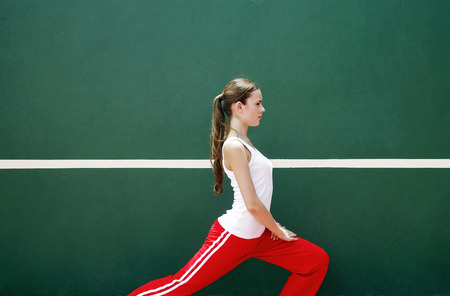 Woman exercising in the tennis court