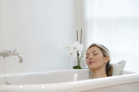 Woman resting in bathtub
