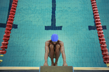 Man hanging onto the starting block