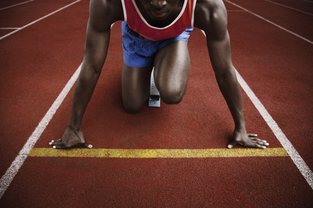 Man in starting position on running track