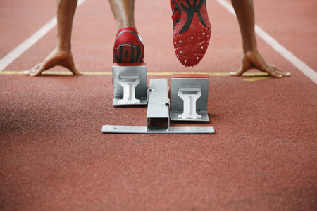 Man in starting position on running track