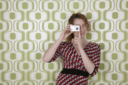 Woman taking picture with digital camera