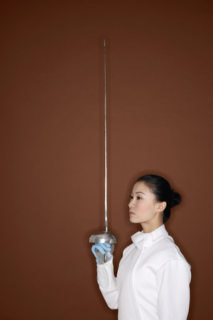 Woman in fencing suit with fencing foil