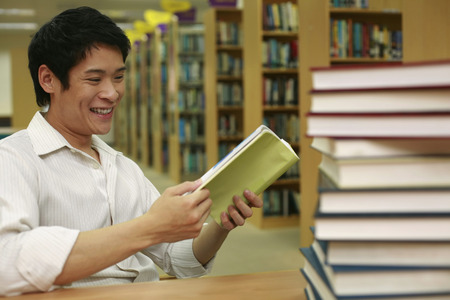 Man reading a book in the library