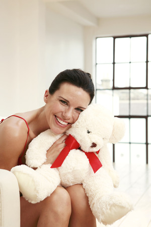 Woman hugging a soft toyの写真素材