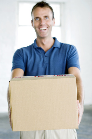 A man passing over a parcel happilyの写真素材