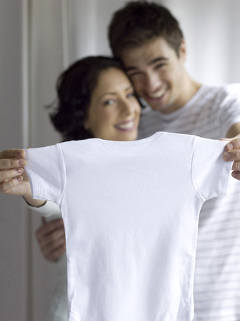 Couple showing a white shirtの写真素材