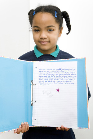 Girl showing her good essayの写真素材