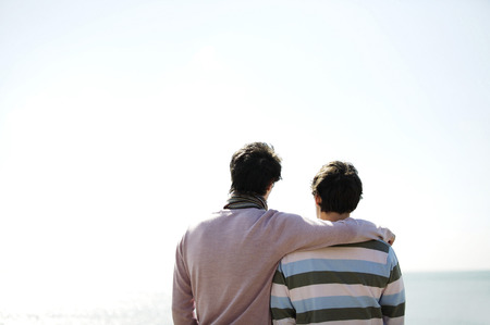 Man putting arm around his friendの写真素材