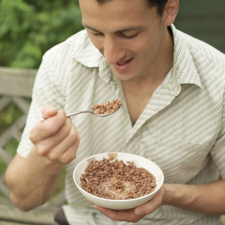 Man enjoying a bowl of breakfast cerealの写真素材