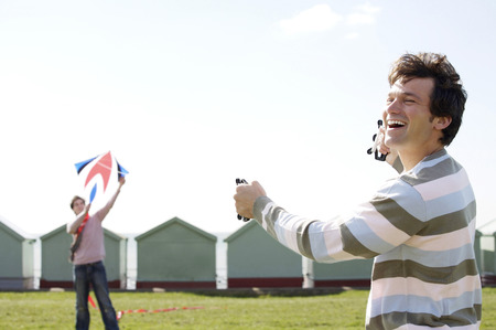 Two men flying kite
