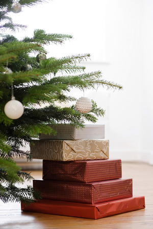 Gifts piled under a Christmas treeの写真素材