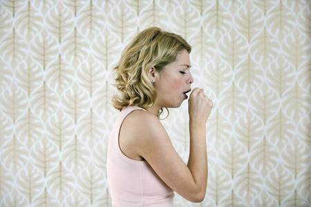 A woman coughingの写真素材