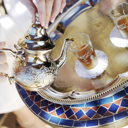Pouring Moroccan tea from teapotの写真素材