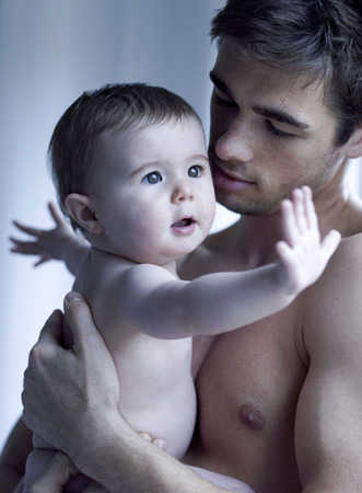 Father carrying baby girlの写真素材