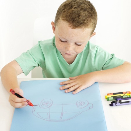 Boy drawing a carの写真素材
