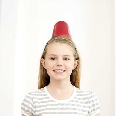 Girl with party hat smiling at the cameraの写真素材