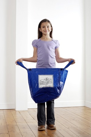 Girl holding a recycling plastic bagの写真素材