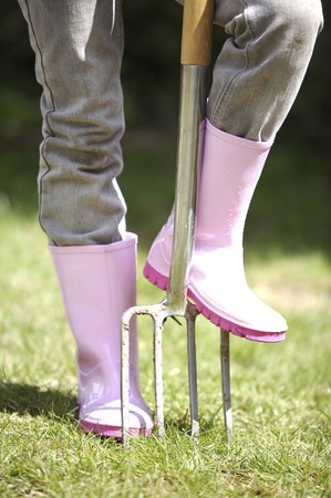 Girl stepping on a pitchforkの写真素材