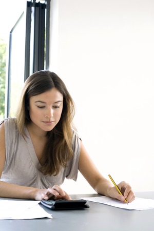 Woman working out some calculationsの写真素材