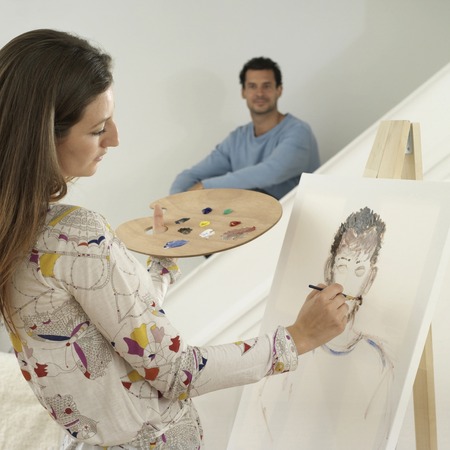 Woman painting man's portraitの写真素材