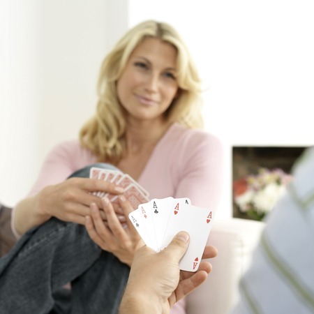 Man and woman playing with cardsの写真素材