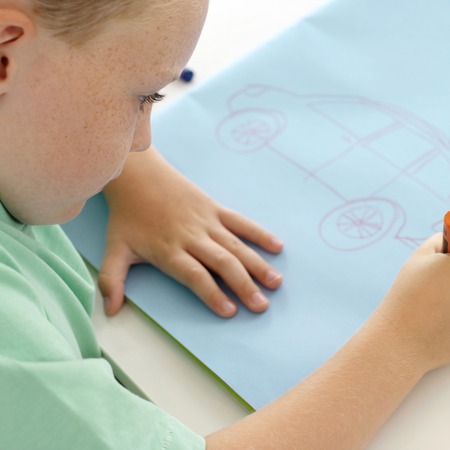 Boy drawing a carの写真素材