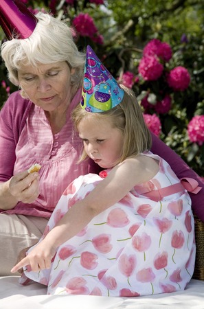 Mother and daughter celebrating birthday in the park