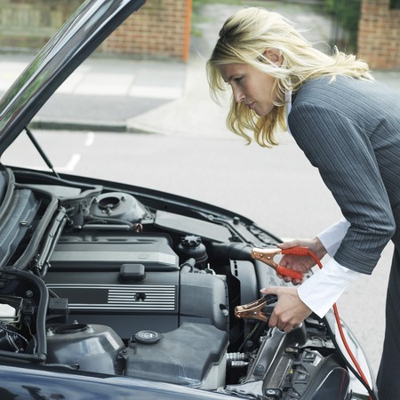 Businesswoman using jumper cablesの写真素材