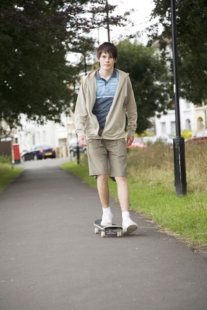 Boy playing with skateboardの写真素材