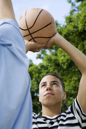 Boys playing basketball in the park