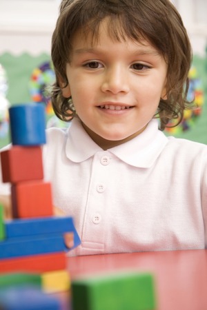 Boy playing with wooden blocksの写真素材