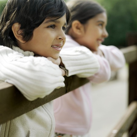 Boy and girl at the fenceの写真素材