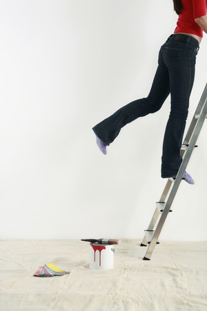 Woman climbing up ladderの写真素材