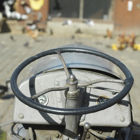 Close-up on the steering wheel of a tractorの写真素材