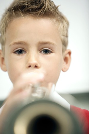 Boy blowing a trumpet