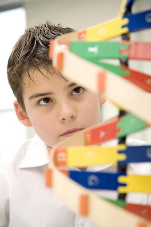 Boy looking at molecular structureの写真素材