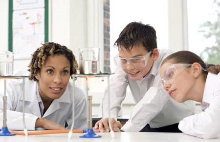 Woman with boy and girl carrying out science experimentsの写真素材